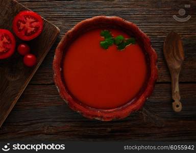 Tomato sauce on clay dish and dark wood background