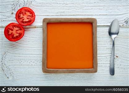 Tomato sauce on square clay dish and white wood