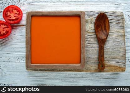 Tomato sauce on square clay dish and white wood