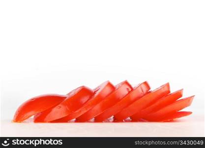 Tomato sliced on cut board. Fresh tomato sliced in to seperate pieces
