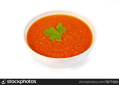 Tomato soup in a white bowl with parsley and pepper isolated on white background
