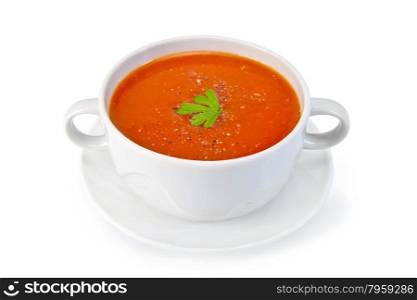 Tomato soup in a white bowl with parsley and spices on a saucer isolated on a white background. Soup tomato with parsley in white bowl on saucer