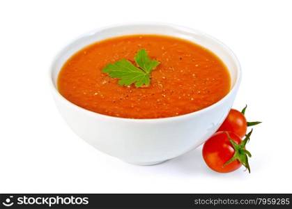 Tomato soup in a white bowl with parsley and tomatoes isolated on white background. Soup tomato in white bowl with cherry tomatoes