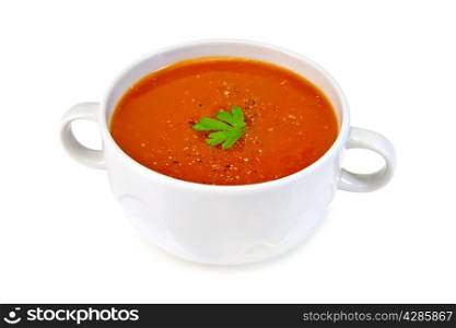 Tomato soup in a white bowl with parsley isolated on white background
