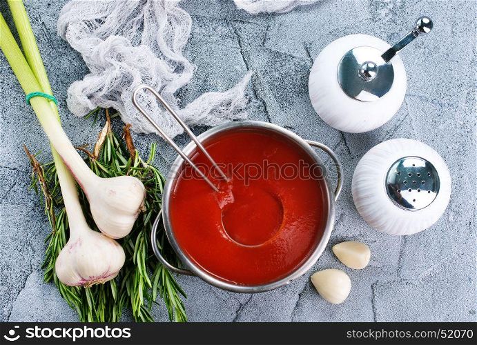 tomato soup in bowl and on a table