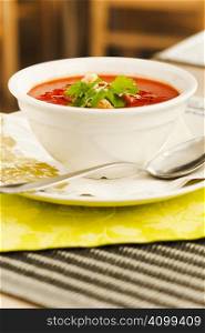 Tomato soup with bread crumps and leaves
