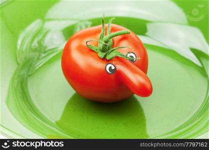 tomato with a nose on a green plate