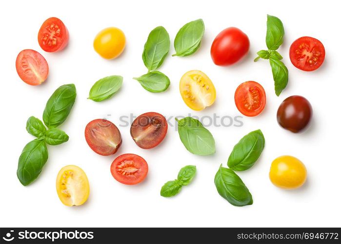 Tomatoes and basil leaves isolated on white background. Top view