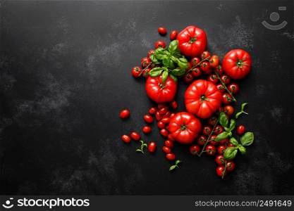Tomatoes and basil on black background, top view, flat lay