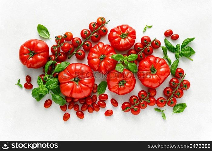 Tomatoes and basil on white background, top view, flat lay
