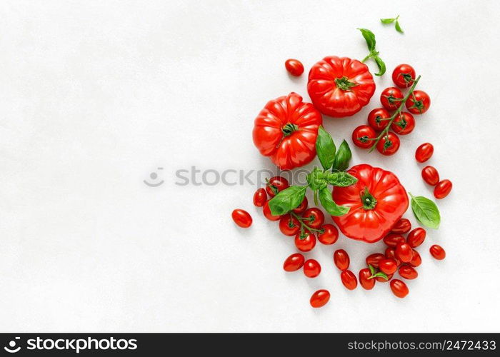 Tomatoes and basil on white background, top view, flat lay