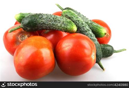 Tomatoes and cucumber isolated on white.