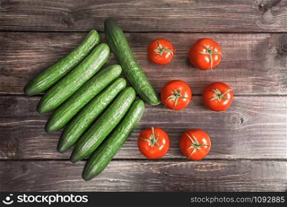 Tomatoes and cucumbers on a wood board.