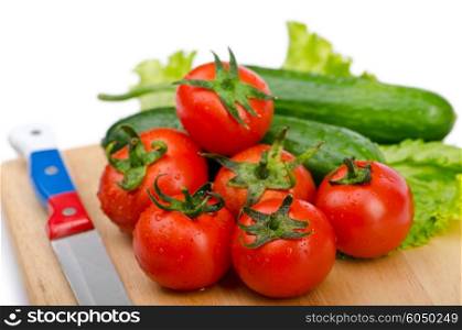 Tomatoes and cucumbers on white