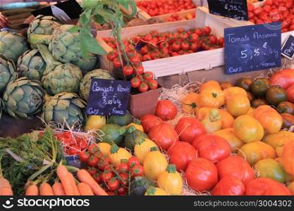 Tomatoes and other vegetables at a market in the Provence