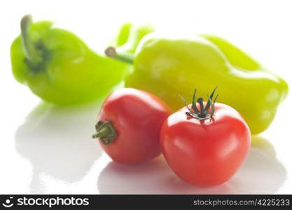 tomatoes and peppers isolated on white
