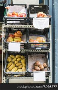Tomatoes and potatoes in crates in a shop