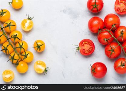 Tomatoes assortment, fresh red ripe on branch, red and yellow, whole and cut in half, on rustic table top view.