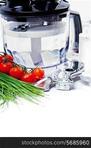 Tomatoes, chives and blender for cooking