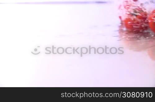 Tomatoes Falling in Slow Motion in water.Shot in 200 fps