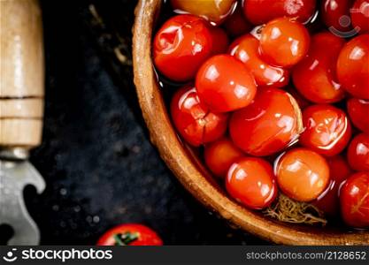 Tomatoes for marinating in a wooden plate. On a black background. High quality photo. Tomatoes for marinating in a wooden plate.