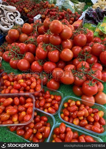 Tomatoes for sale on a market stall on market day in the town of Malton in North Yorkshire, United Kingdom.