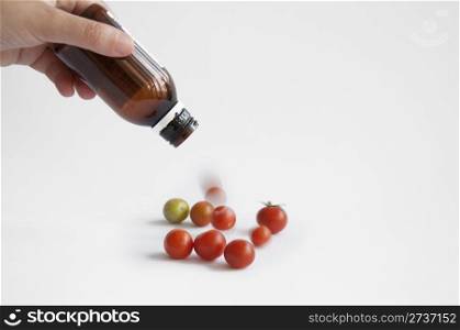 Tomatoes from the medication bottle solated on white