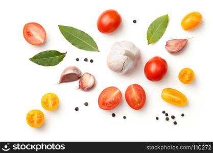 Tomatoes, garlic, bay leaves and peppercorn isolated on white background. Top view