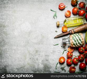 Tomatoes in the background. Fresh tomatoes, olive oil and spices. On a stone background. . Tomatoes in the background. Fresh tomatoes, olive oil and spices.