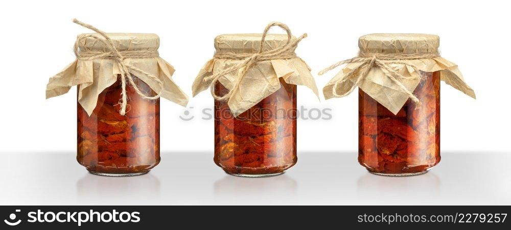Tomatoes in the jar. Homemade sun dried tomatoes. temporary closing-down. Summer and autumn canned food. conserve with spices and vegetables. Isolated on white background with clipping path