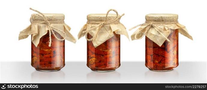 Tomatoes in the jar. Homemade sun dried tomatoes. temporary closing-down. Summer and autumn canned food. conserve with spices and vegetables. Isolated on white background with clipping path