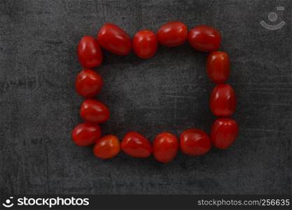 Tomatoes on dark rock background