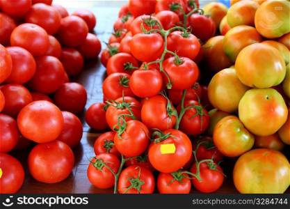 Tomatoes stacked in vegetables market different species