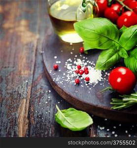 Tomatoes with basil on wooden table background. Food composition.