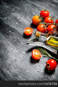 Tomatoes with olive oil. On black rustic background.. Tomatoes with olive oil.