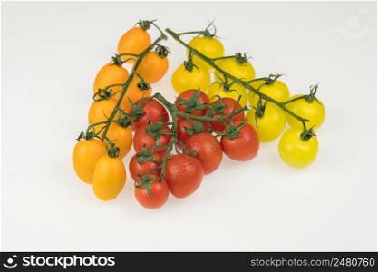 tomatoes with water drops in a glass bowl on a white background, top view. tomatoes in a glass bowl