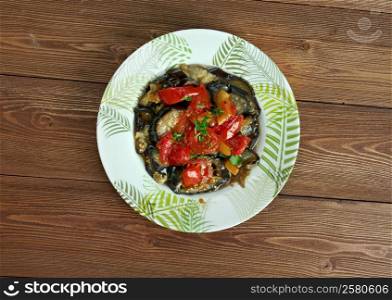 Tombet - traditional vegetable dish from Majorca. sliced aubergines and red bell peppers fried in olive oil.