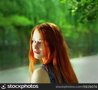 Toned image of pretty women with red hairs outdoors.