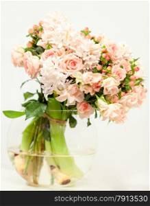 Toned photo of beautiful fresh pink flowers in glass vase