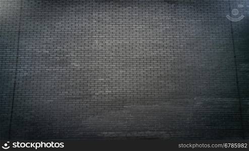 Toned photo of big black brick wall
