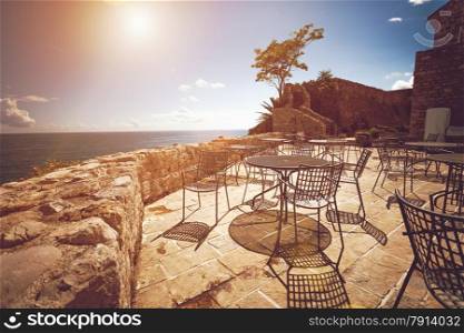 Toned photo of old restaurant summer terrace at sunny day