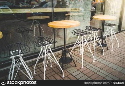 Toned photo of outdoor cafe with metal chairs and tables