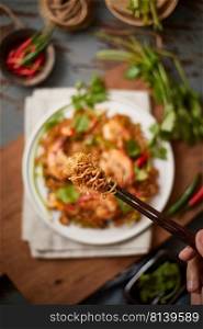 Tong the noodle by chopsticks, Selective focus 