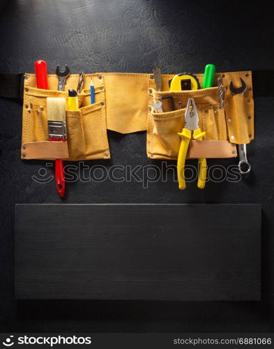 tools and instruments in belt on black background