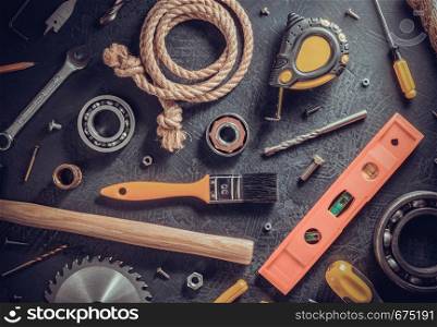 tools and instruments on black table background, top view