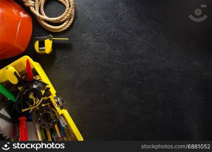 tools and instruments with toolbox on black background