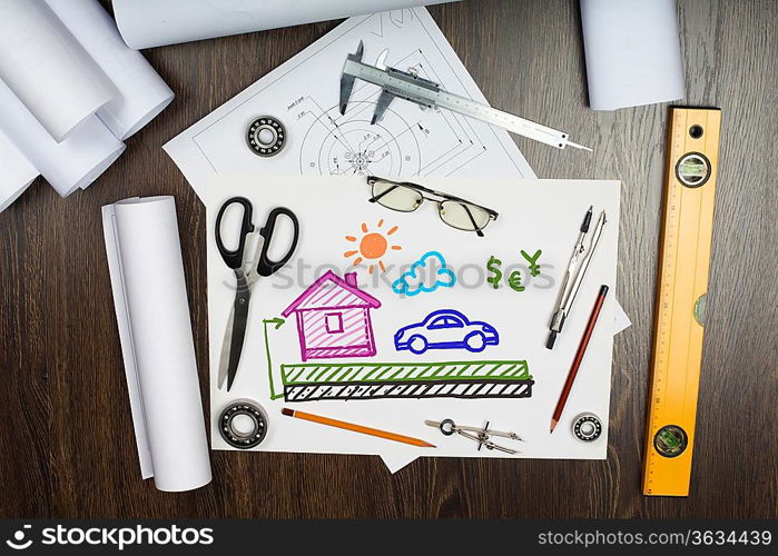 Tools and papers on the table with a picture of a house