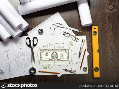 Tools and papers on the table with financial symbols