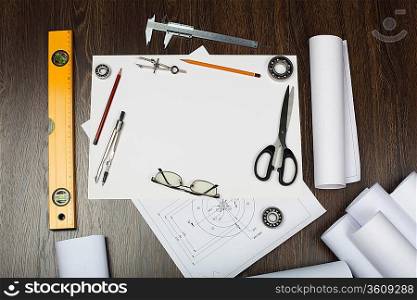 Tools and papers with sketches on the table