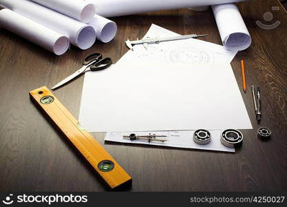 Tools and papers with sketches on the table